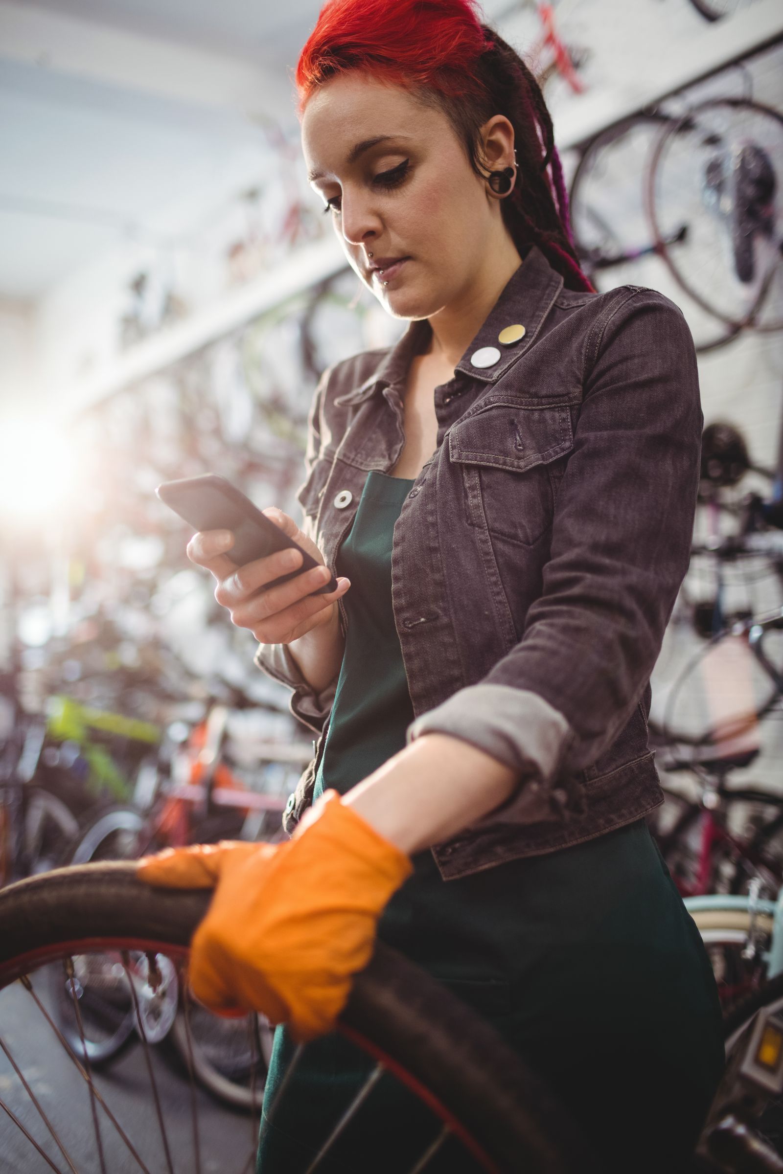 Mécanicien vélo consultant l'application Bécik sur son téléphone